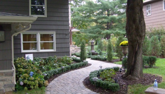 WIllow Creek Pavers lead to the entrance of this Mound Home
