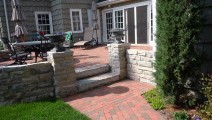 Chilton stone mortared retaining wall and pillars, clay paver patio in Minneapolis